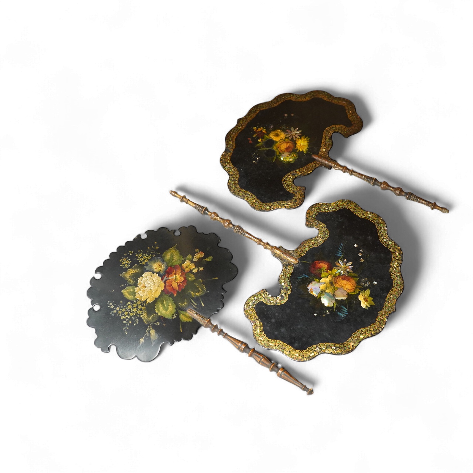 Three early Victorian papier maché hand screens, two with abalone inlay, 39cm in length